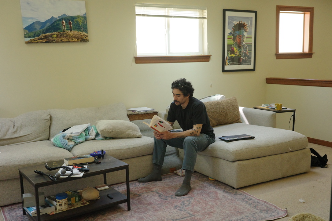 A man reading a book, unaware his photograph is being taken