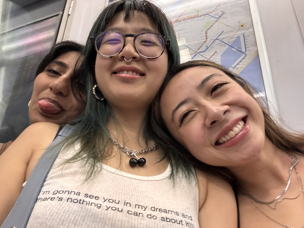 Ishita, Leighann and me smiling on the train